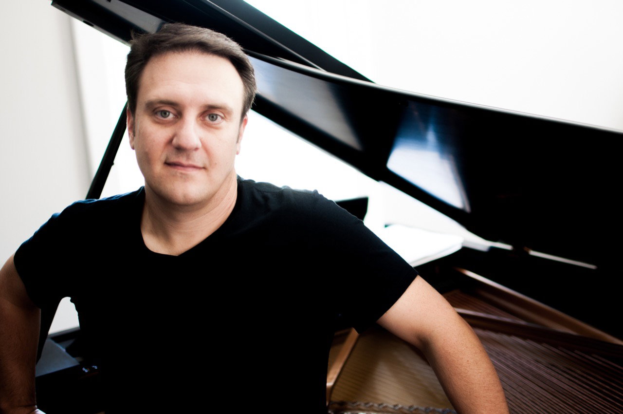 Jason Webb in front of an open grand piano